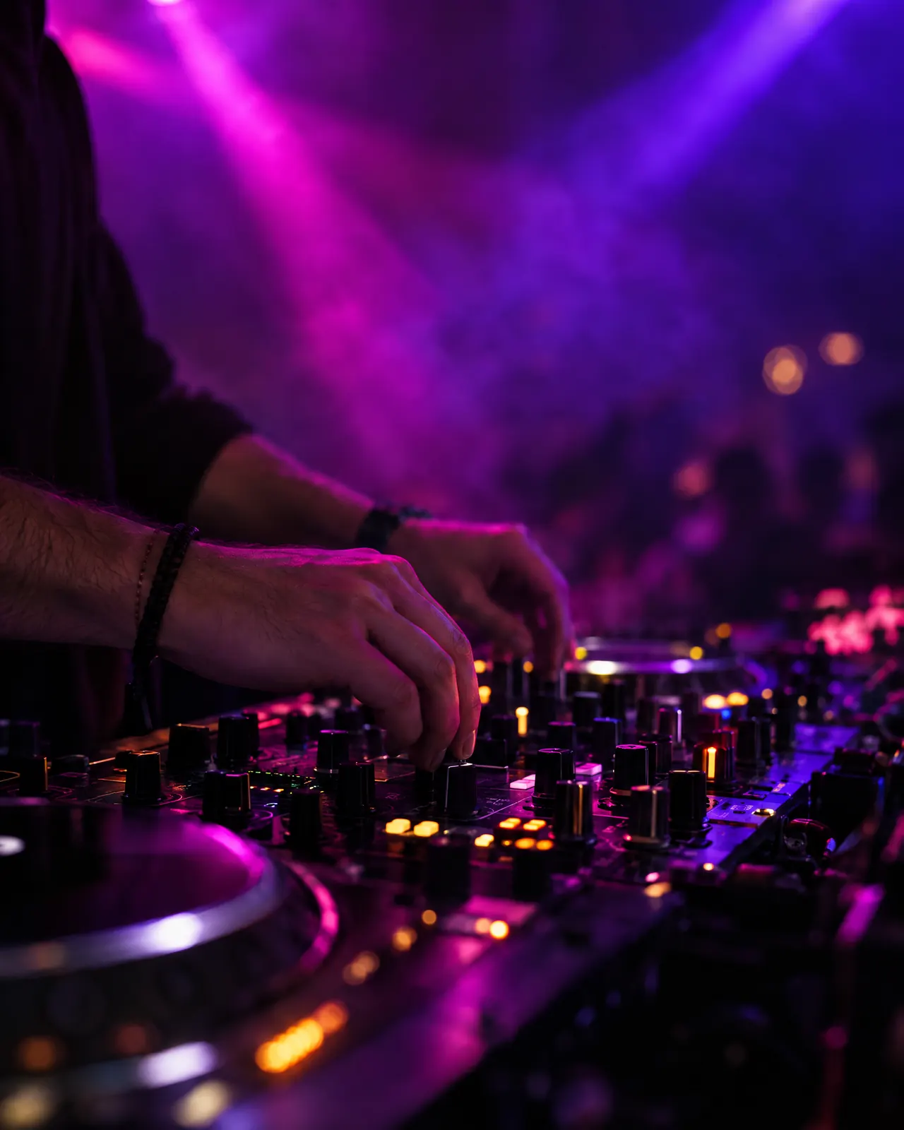 DJ mezclando en la cabina de un club de Ibiza con luces violetas